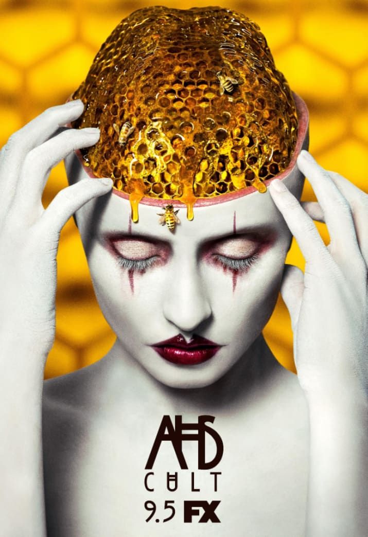 a woman with white makeup holding her head covered in honeycombs and dripping yellow liquid