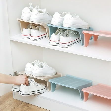 there is a person reaching for shoes on the shelf in front of two shelving units