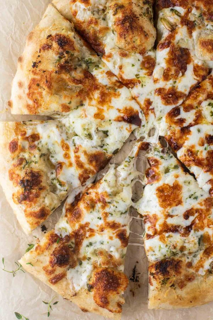 a close up of a sliced pizza on a plate with text that reads garlic pizza