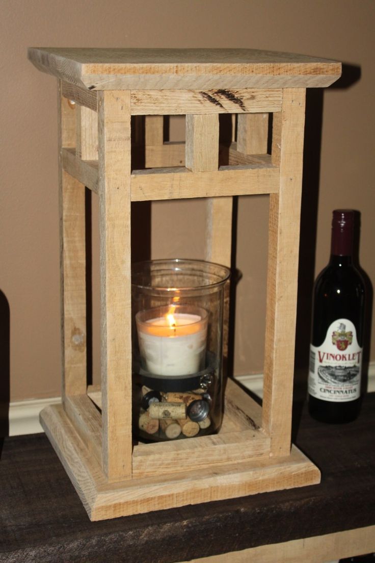 a candle is lit in a wooden lantern