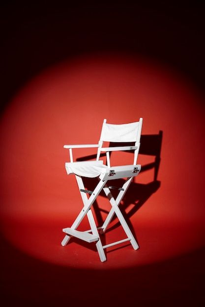 a white chair sitting on top of a red floor