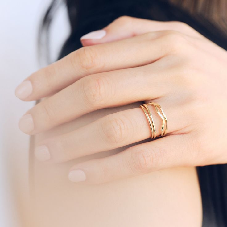 Fall in love with our stunning Wave ring. This unique piece features a delicate wave design that embodies the fluidity and beauty of the ocean. Made with high-quality materials, this ring is not only eye-catching but also durable. Bring the tranquility of the sea wherever you go with our Wave ring. 14k Solid Gold To maintain its shine, avoid harsh chemicals, abrasives, and excessive contact with lotions or perfumes. Store each piece separately in soft pouches or compartments in a dry, cool place Adjustable Wavy Stackable Jewelry, Adjustable Stackable Wavy Jewelry, Modern 14k Gold Wavy Jewelry, Modern Wavy 14k Gold Jewelry, Modern Wavy Jewelry For Anniversary, Modern Jewelry For Anniversary, Minimalist 14k Gold Wavy Jewelry, Minimalist Wavy Rings As A Gift, Minimalist Wavy Rings For Gift