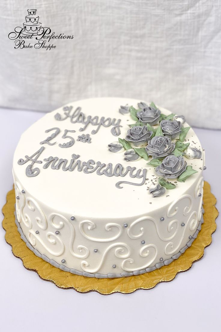 a white cake with silver frosting and roses on top