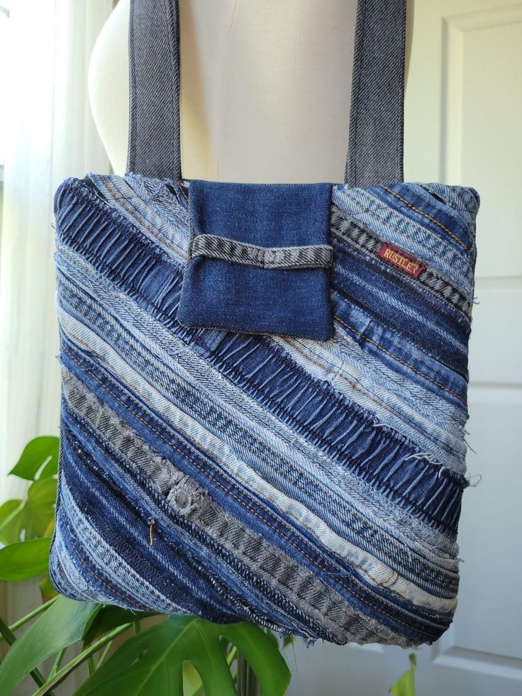 a bag made out of jeans hanging from a mannequin