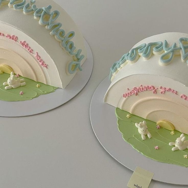 two birthday cakes decorated with sheep and grass