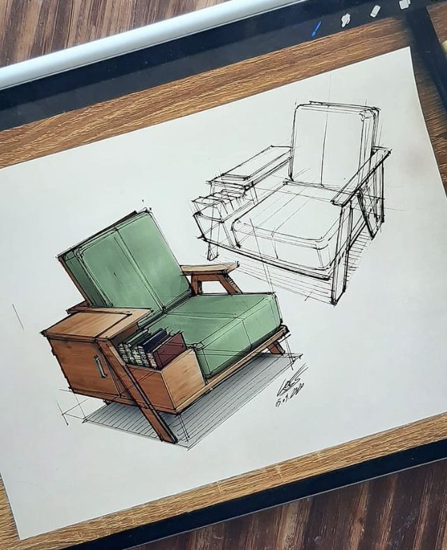 a drawing of a chair and ottoman on top of a wooden table next to a laptop computer