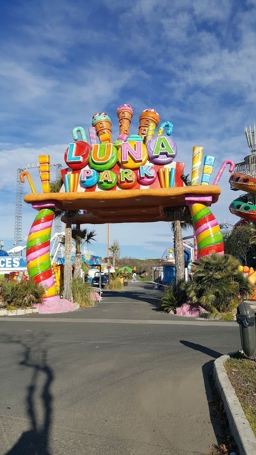 the entrance to an amusement park that is decorated in bright colors