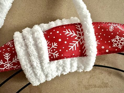 a red and white snowflaked christmas ribbon on top of a headband