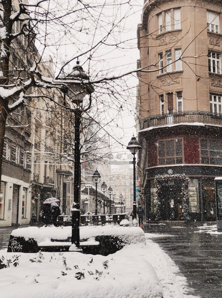 a city street with snow on the ground