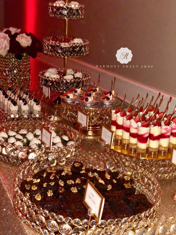 a table topped with lots of desserts and cupcakes