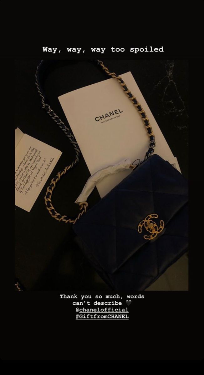 a chanel bag sitting on top of a table next to a note and envelope