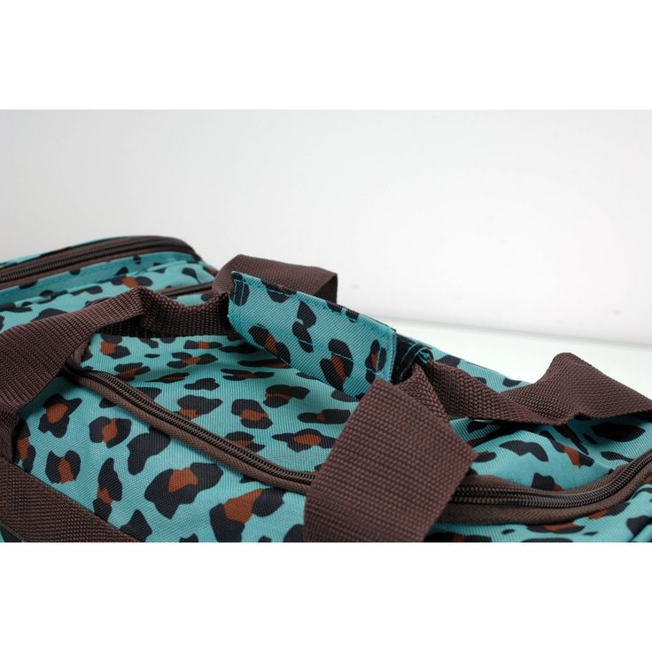 a blue and brown leopard print duffel bag on a white surface with the handles down