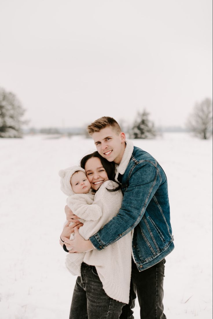 a couple hugging each other in the snow