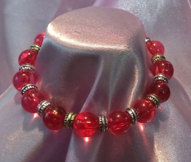 Elastic bracelet with red and silver beads Red Handmade Jewelry, Red Beaded Bracelets With Large Beads As Gift, Handmade Red Beaded Bracelets For Party, Red Stretch Bracelet With Round Beads For Gifting, Red Beaded Bracelets With Large Beads For Gifts, Red Beaded Stretch Bracelet As Gift, Red Bracelet Jewelry For Holidays, Elegant Red Stretch Bracelet For Party, Spiritual Red Stretch Bracelet As Gift