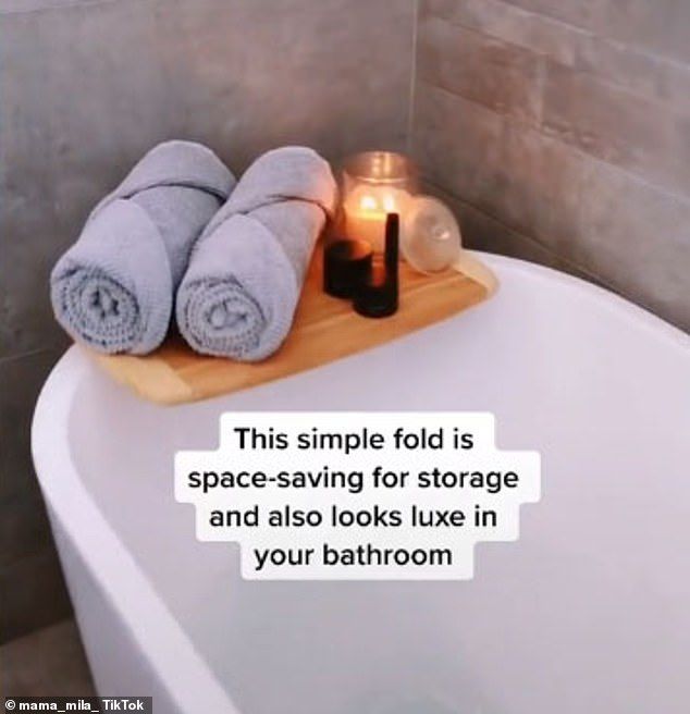 a bathtub with two towels on it and a candle in the middle that reads, this simple fold is space - saving for storage and also looks like in your bathroom