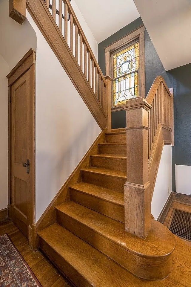 a wooden staircase leading up to a window