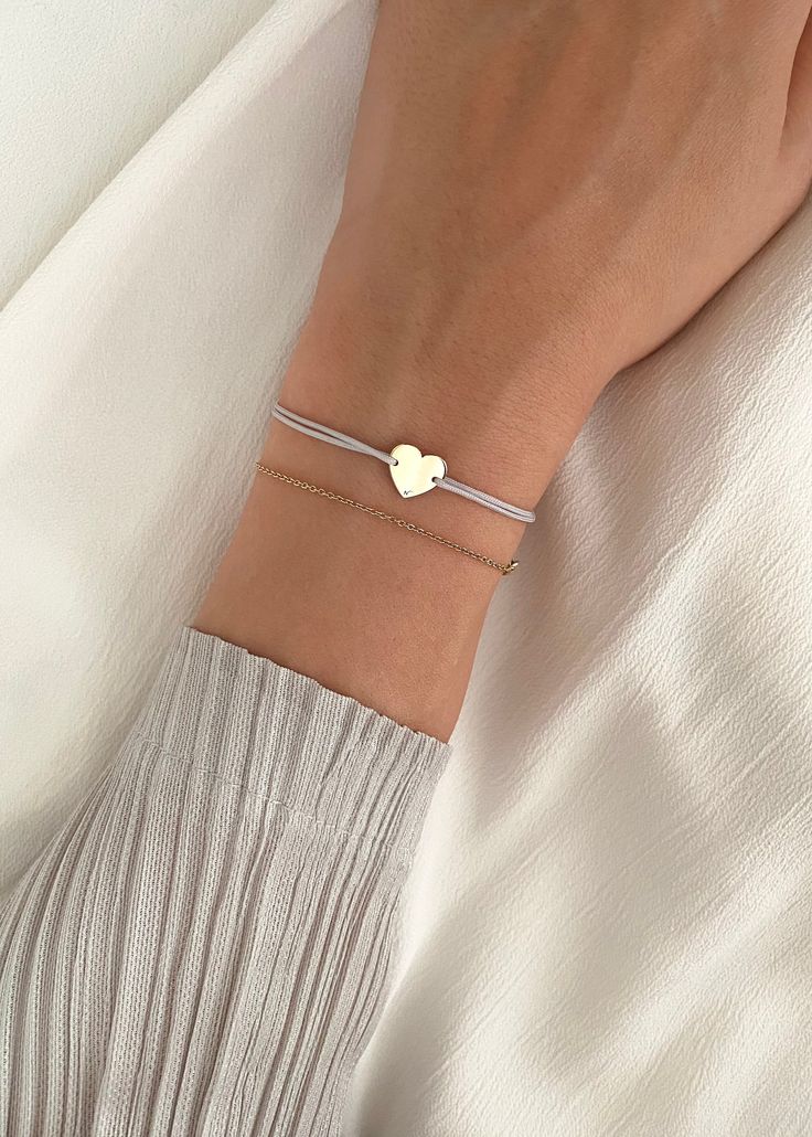 HEART BRACELET A simple symbol of love, our Heart is made from solid gold 14K, set on an adjustable string.  Add this meaningful bracelet to your collection today and let it inspire you to bring your dreams of motherhood into the world. Safe to wear all the time, including in contact with water. The solid gold charm will not get damaged, tarnish or change color. FREE SHIPPING WORLDWIDE PROCESSING TIME: 1-2 business days MATERIAL : High quality solid 14 k gold SIZE : Adjustable. Our Heart bracele Adjustable Yellow Gold Minimalist Heart Bracelet, Adjustable Minimalist Yellow Gold Heart Bracelet, Adjustable Rose Gold Heart Bracelet Minimalist Style, Classic Adjustable Bracelets With Heart Charm, Classic Adjustable Bracelet With Heart Charm, Simple 14k Gold Bracelets As Gift, Minimalist Yellow Gold Bracelets For Mother's Day, Delicate Adjustable Heart Bracelet For Everyday, Adjustable Delicate Heart Bracelet For Everyday