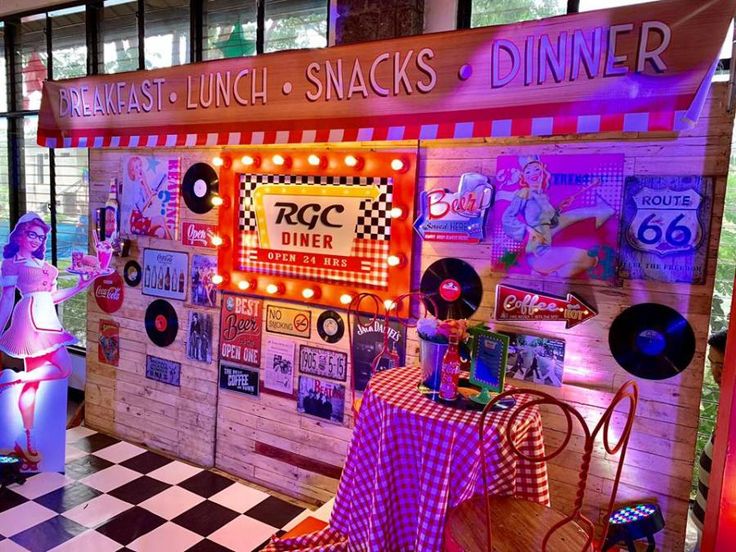 a booth that has some food on it and lights in the front, along with checkered table cloths