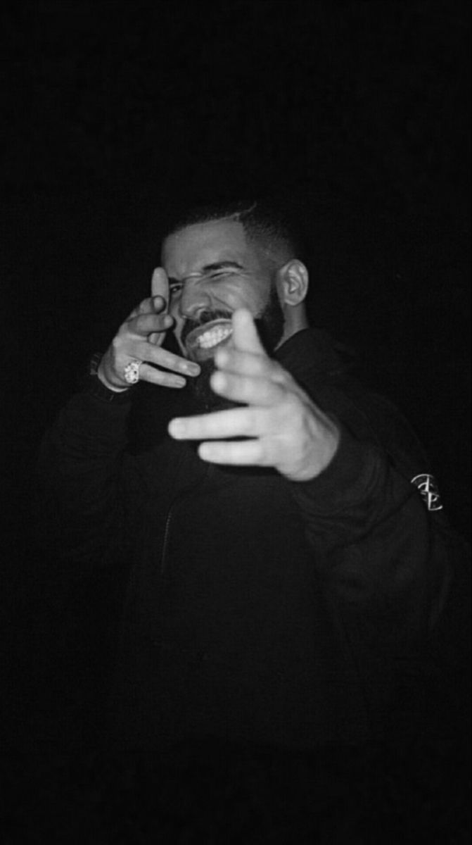 a black and white photo of a man talking on a cell phone in the dark