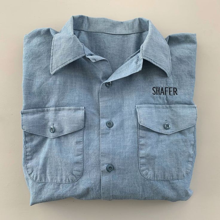 Vintage US Navy chambray shirt. Heavyweight cotton. Button closures. Collar stays. Two chest pockets. Shafer is embroidered on chest and stamped on tail. Measurements (taken flat) ~ Labeled size: none Fits like: mens small/medium Shoulders: 18" Chest: 21 1/2" Sleeves: 23" Length: 31" Condition: great Very little signs of wear. Ink flaw in the S on back side. Tons of life left in this bad boy! Find me on Instagram @mimileather. More military clothing here: www.etsy.com/shop/mimileather?section_id=18050328 Casual Embroidered Button-up Camp Shirt, Cotton Camp Shirt With Embroidered Camp Collar, Casual Embroidered Cotton Camp Shirt, Cotton Camp Shirt With Patch Pockets And Spread Collar, Embroidered Cotton Shirt With Camp Collar, Chambray Collared Tops With Pockets, Cotton Embroidered Shirt With Camp Collar, Cotton Camp Shirt With Pockets And Camp Collar, Cotton Camp Shirt With Pockets And Spread Collar