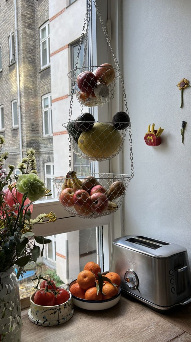 a window sill filled with fruit next to a toaster