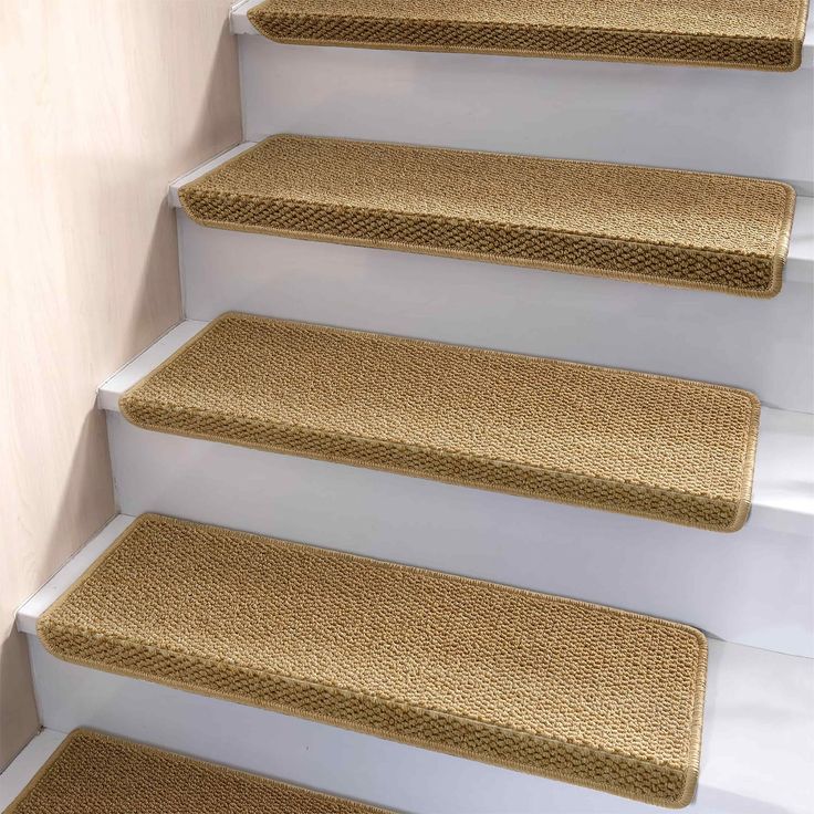 a set of beige carpeted stairs with white handrails