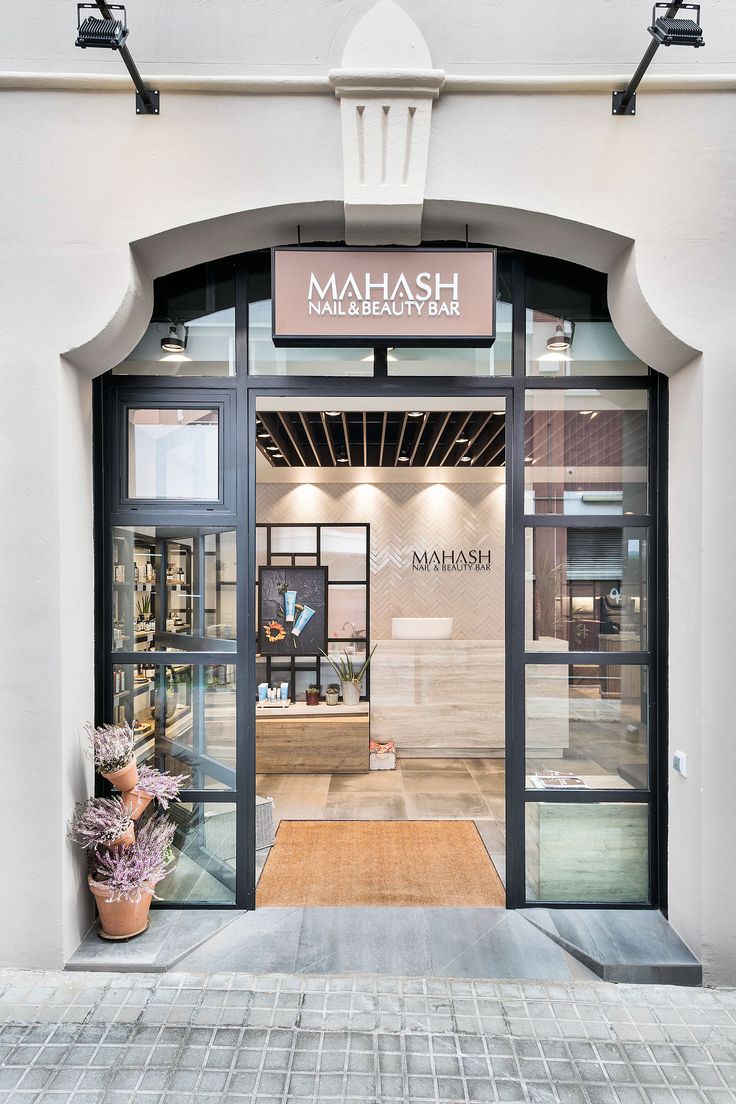 an entrance to a store with glass doors