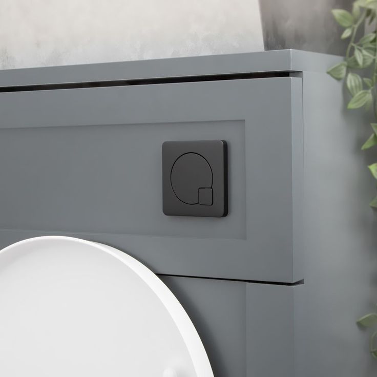 a white sink sitting next to a gray cabinet with an elephant symbol on the front