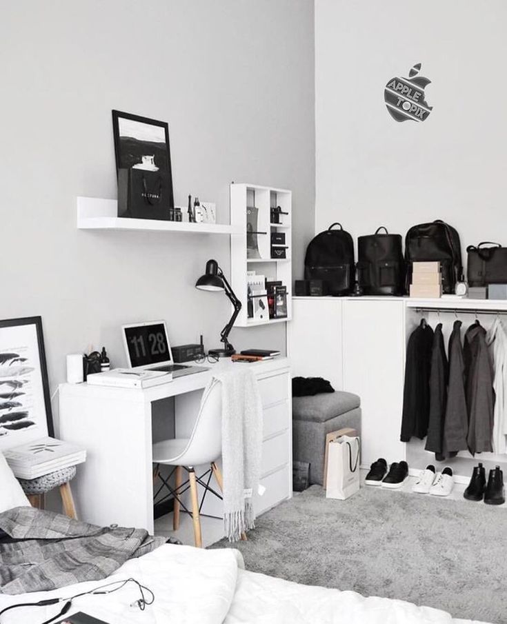 a bedroom with a bed, desk and shelves on the wall next to each other