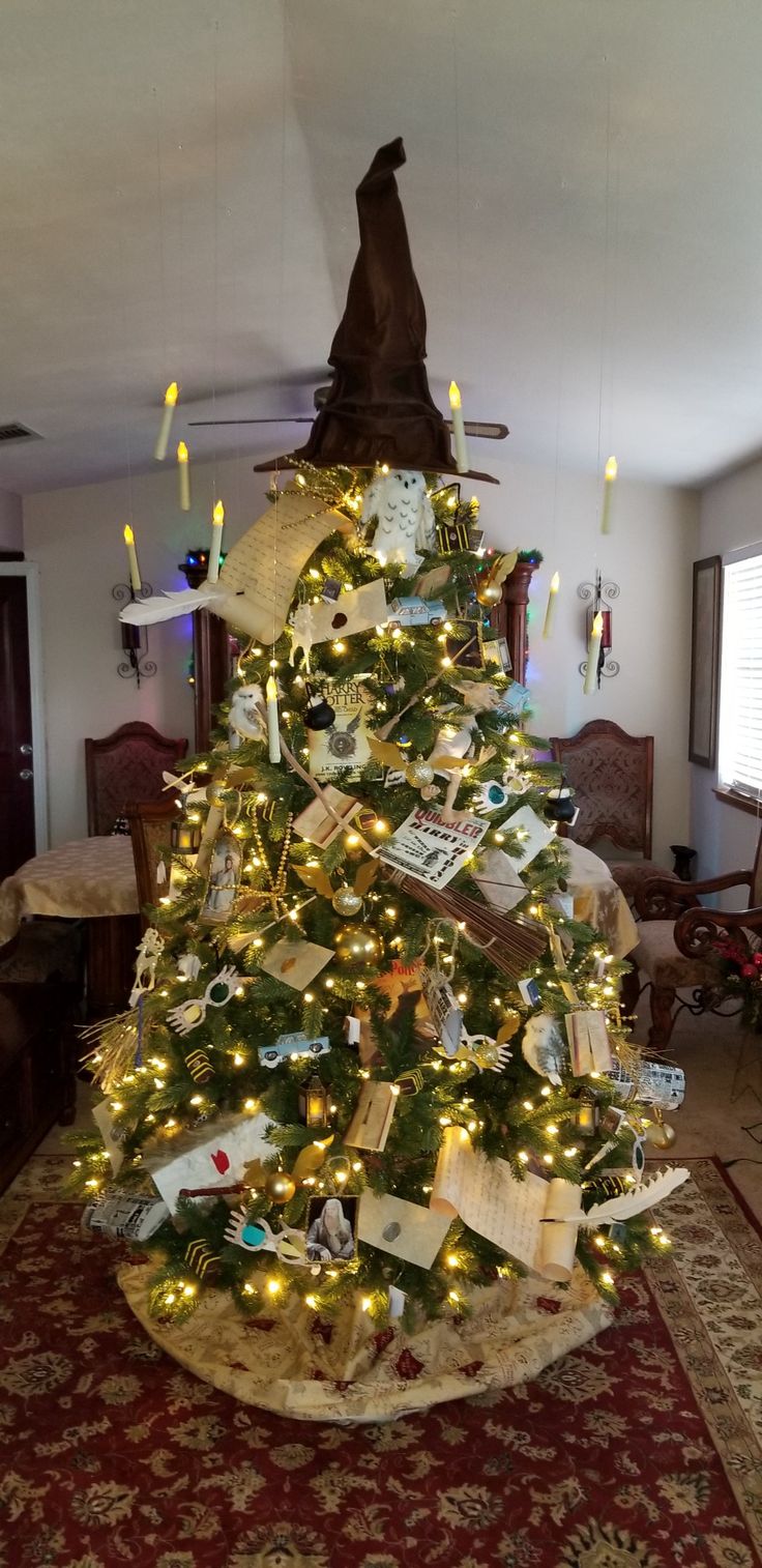 a decorated christmas tree in the middle of a living room with many lights on it