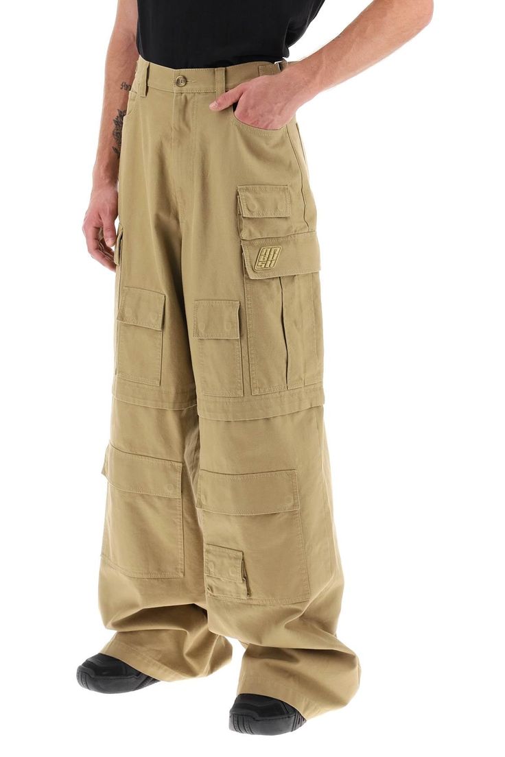 These Ambush wide-leg cargo pants are crafted of cotton basketweave and showcase a five-pocket style in addition to multiple flap pockets along both legs. Cut in a mid-rise, this piece is finished with adjustable side waist straps, belt loops and a zip fly with button fastening. The model is 187 cm tall and wears a size M. Size Info STANDARD Color Detail Beige Made In Italy Material 100%CO Season One spring Season Two summer Product clothing Brand Ambush Size And Fit Baggy Military Cargo Pants With Patch Pockets, Baggy Utility Cargo Jeans, Military Style Baggy Parachute Pants With Patch Pockets, Techwear Wide Leg Bottoms With Patch Pockets, Military Style Wide Leg Cargo Pants With Flap Pockets, Military Wide Leg Cargo Pants With Flap Pockets, Khaki Parachute Pants With Flap Pockets, Full Length, Baggy Utility Cargo Pants With Pockets, Baggy Wide Leg Utility Cargo Pants