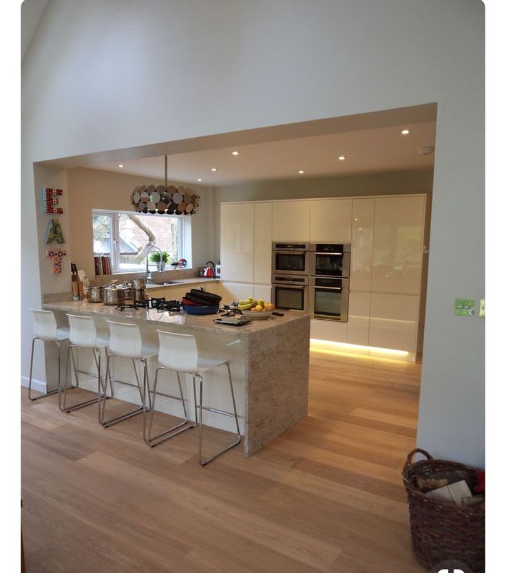 a kitchen with an island and several stools