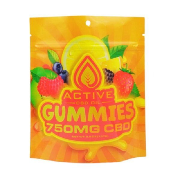 gummies with berries and raspberries are in a plastic bag on a white background