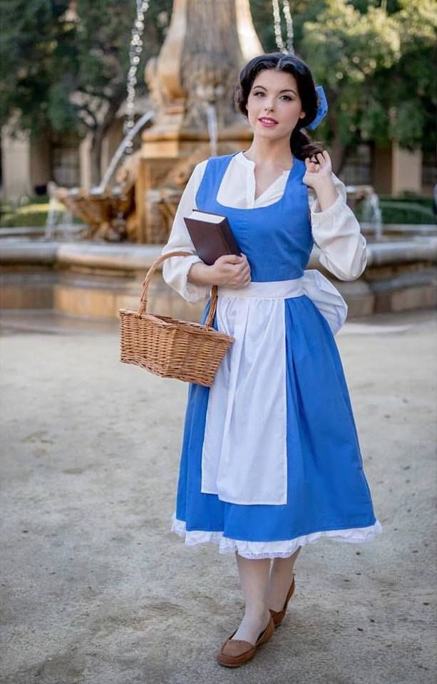 a woman dressed in blue and white holding a basket