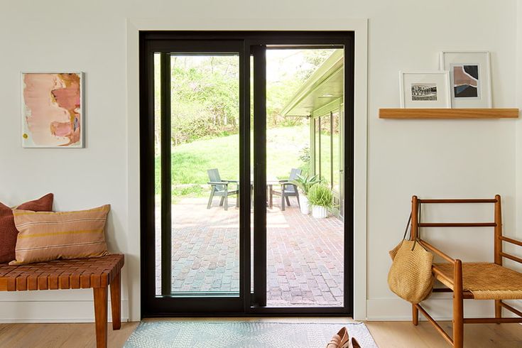 a living room filled with furniture and a sliding glass door