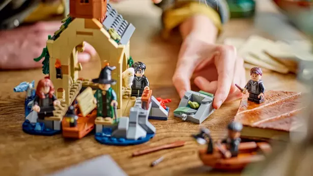 A boy playing with a Harry Potter Lego set