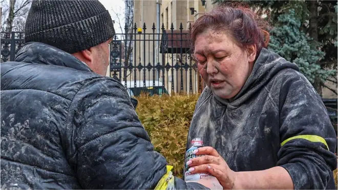 People help a wounded woman in Kharkiv, Ukraine, 1 March 2022