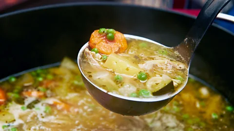 A ladle lifting chicken soup (Credit: Getty Images)