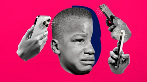 A young boy crying while surrounded by mobile phones taking pictures (Credit: Serenity Strull/Getty Images)