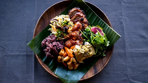 Lauren Cutshall A banana leaf, purple sticky rice and hot sauce add colour and spice to a Hmong feast (Credit: Lauren Cutshall)