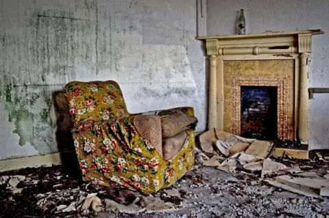 An old armchair in an abandoned room. 