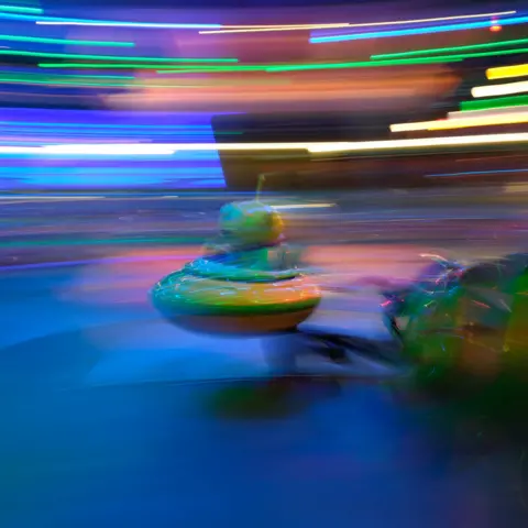 Kirsten Weller An alien figure on a fairground ride