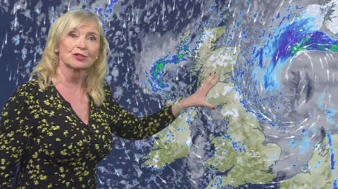 Carol Kirkwood presenting in front of UK weather map