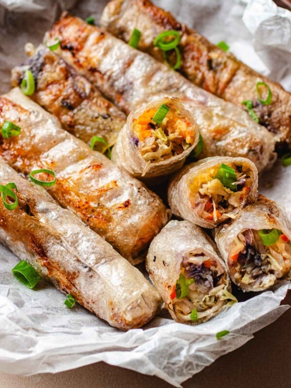 Rice paper egg rolls with vegetables inside and fried to crispy.