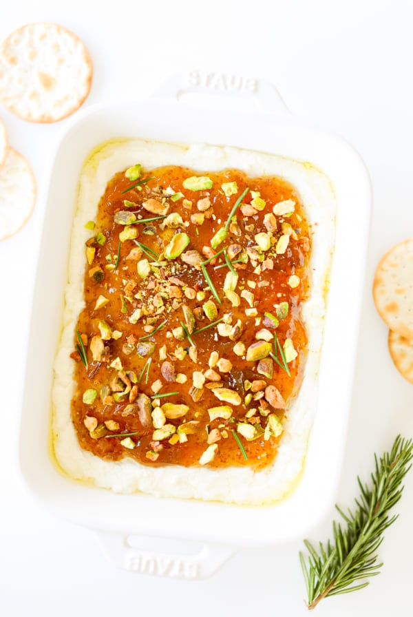 A white dish with pistachio goat cheese spread.