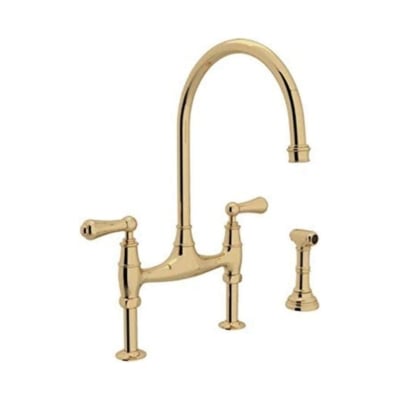 An unlacquered brass kitchen faucet against a white background.