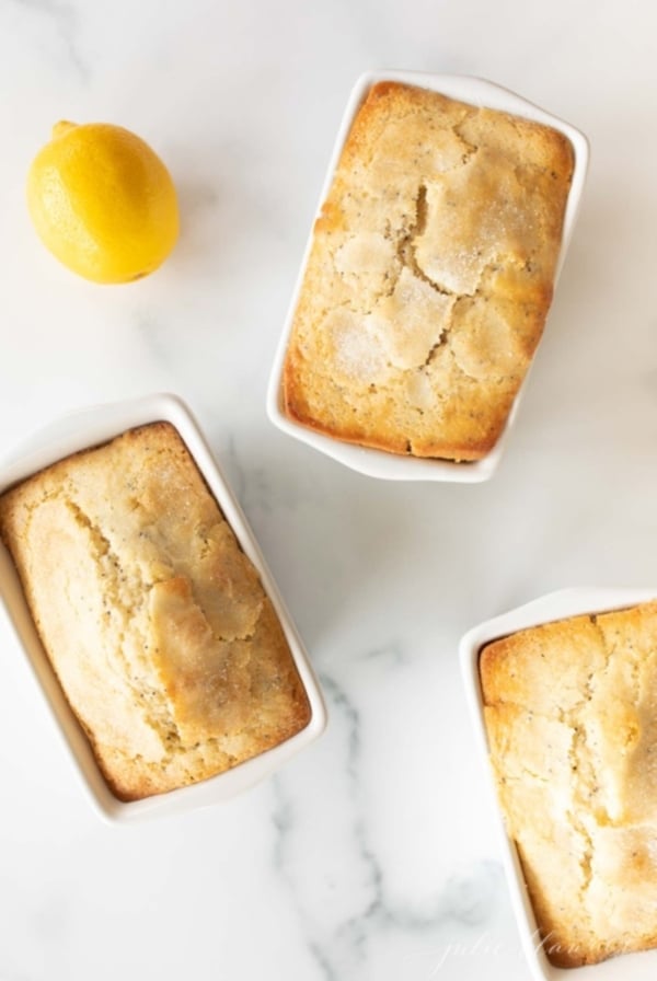 Lemon poppy seed loaves on a marble countertop.