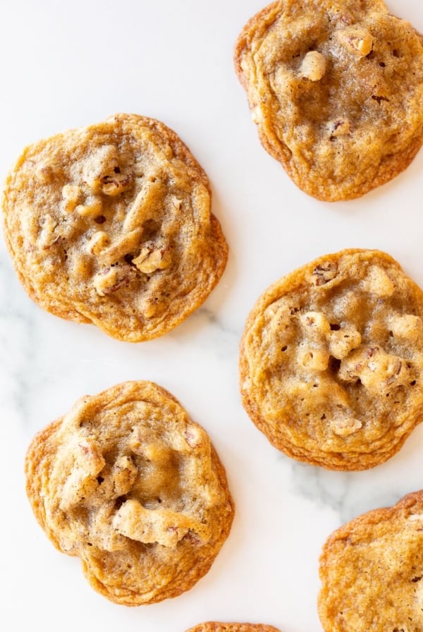 Pecan pie cookies laid out on a white surface.