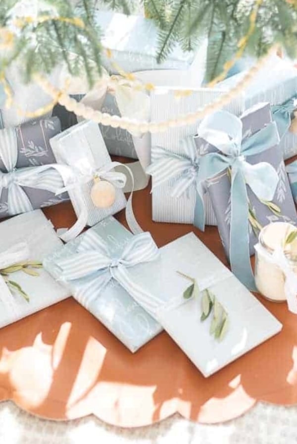 Blue and white Christmas gift wrap under a tree.