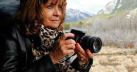 Woman with camera on train.